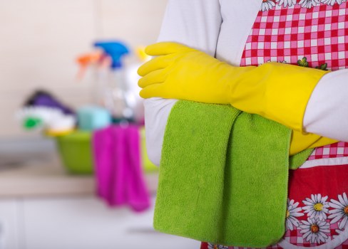 Experienced office cleaners in E1 sanitising a meeting room